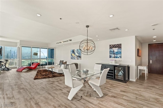 dining room with light wood finished floors, baseboards, visible vents, a chandelier, and recessed lighting