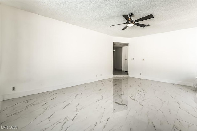 empty room featuring ceiling fan and a textured ceiling