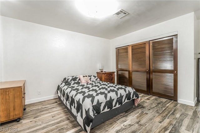 bedroom with hardwood / wood-style floors and a closet