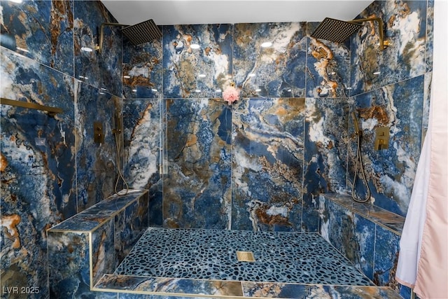 bathroom with a tile shower