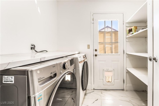 clothes washing area with washer and dryer