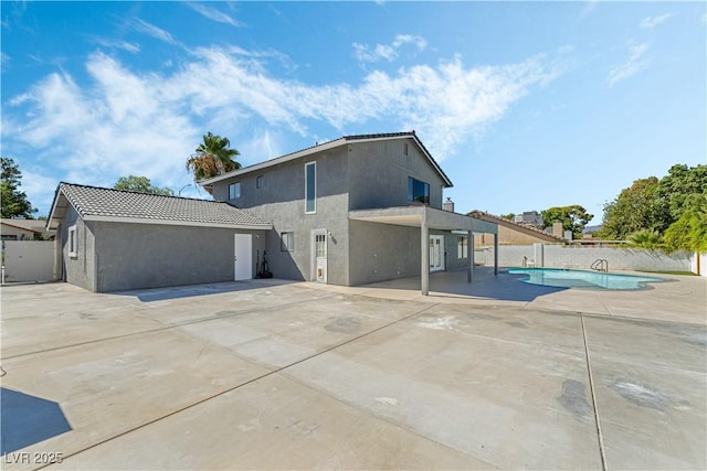 exterior space with a fenced in pool and a patio area