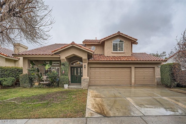 mediterranean / spanish home featuring a garage and a front lawn