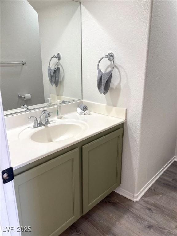 bathroom with hardwood / wood-style flooring and vanity