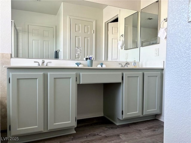 bathroom featuring hardwood / wood-style flooring and vanity