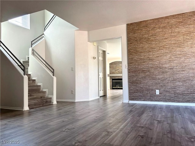 unfurnished living room with dark wood-type flooring