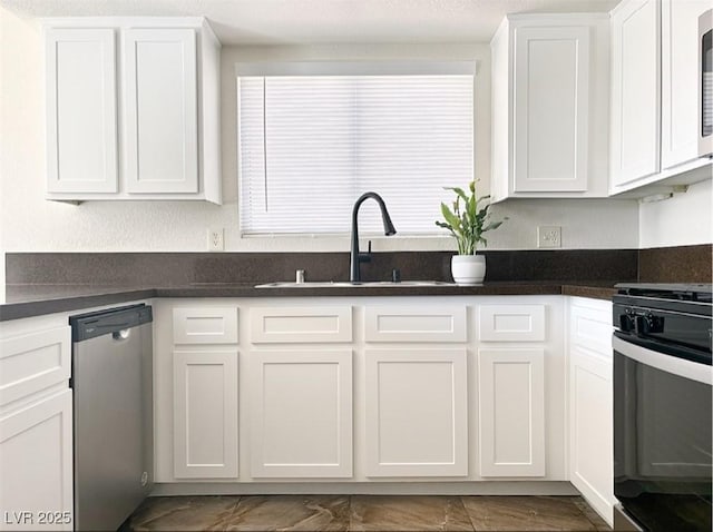 kitchen with black stove, dishwasher, sink, and white cabinets