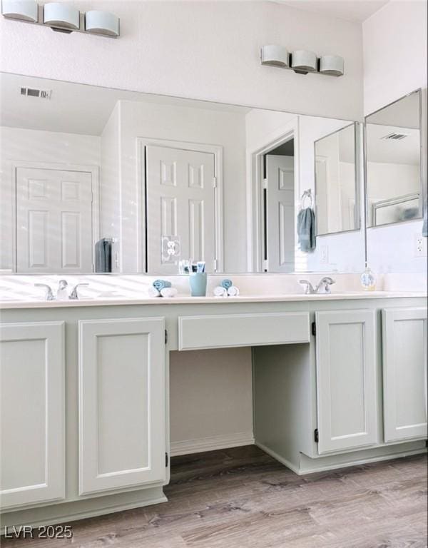 bathroom featuring vanity and hardwood / wood-style floors