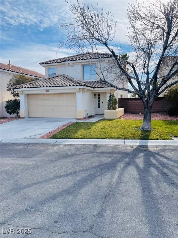 view of front of property with a garage and a front lawn