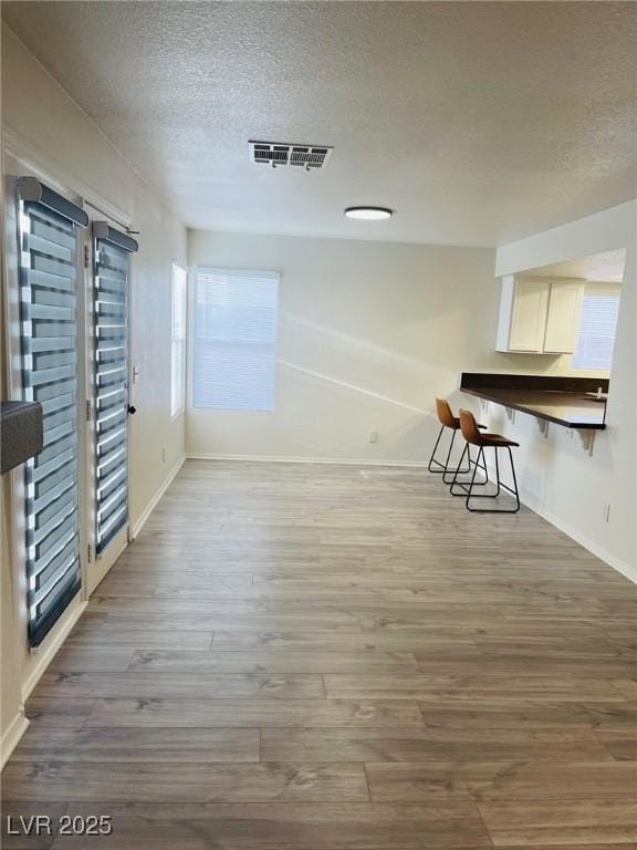 unfurnished room featuring dark hardwood / wood-style flooring and a textured ceiling