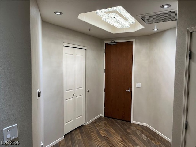 hallway with baseboards, visible vents, dark wood finished floors, and recessed lighting