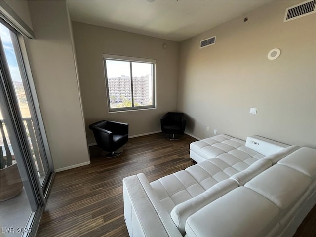 sitting room featuring baseboards, visible vents, and dark wood-type flooring