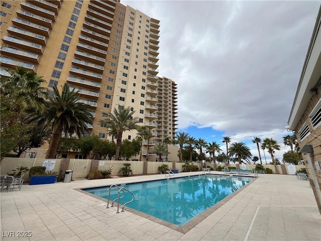 pool featuring a patio area and fence