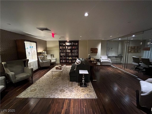 living room with wood finished floors, visible vents, and recessed lighting