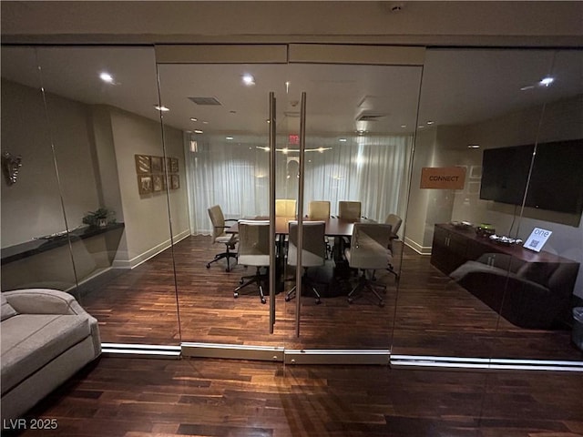 dining area featuring baseboards, visible vents, and wood finished floors