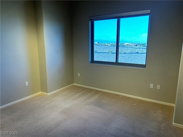 empty room with light carpet and baseboards