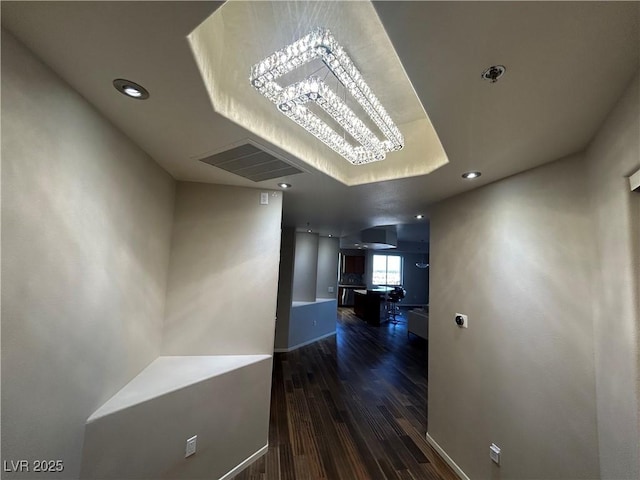 hallway featuring recessed lighting, visible vents, baseboards, and wood finished floors