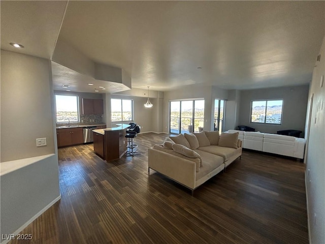 living area featuring dark wood-style flooring, recessed lighting, and baseboards