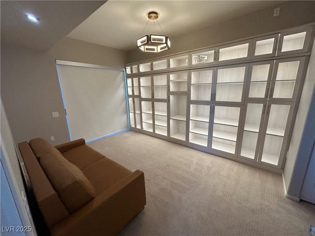 living area featuring carpet floors and baseboards