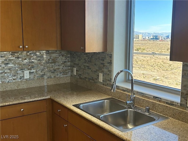 kitchen with light countertops, a sink, and decorative backsplash