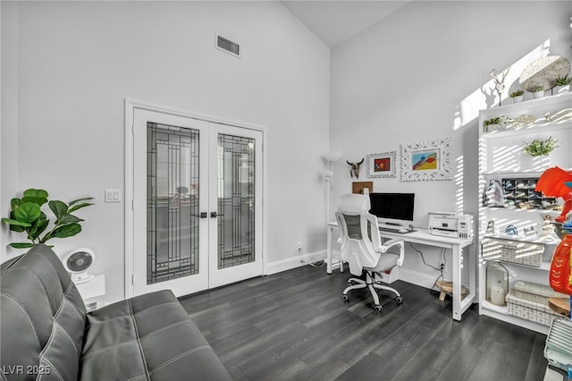 office with dark hardwood / wood-style flooring, high vaulted ceiling, and french doors