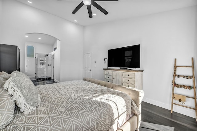 bedroom featuring dark wood-type flooring, ceiling fan, and ensuite bathroom