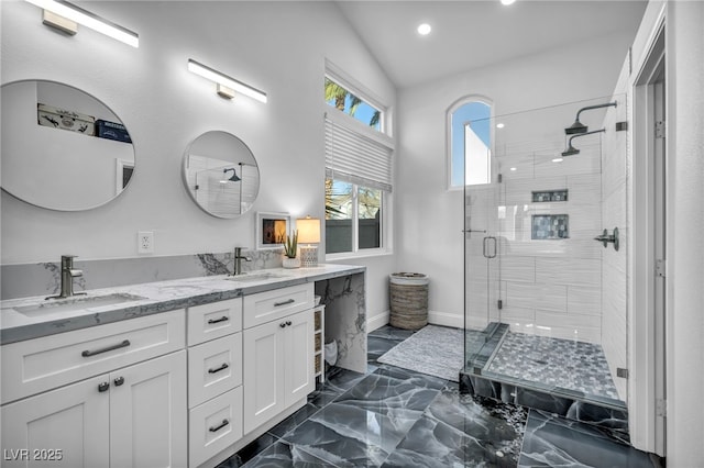 bathroom with vanity, a shower with door, and lofted ceiling