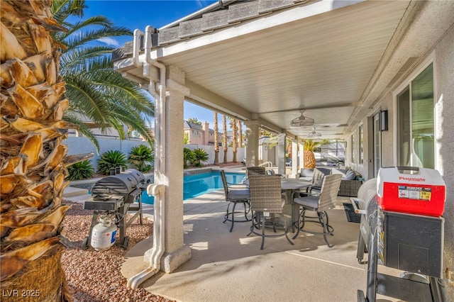 view of patio featuring ceiling fan and a fenced in pool