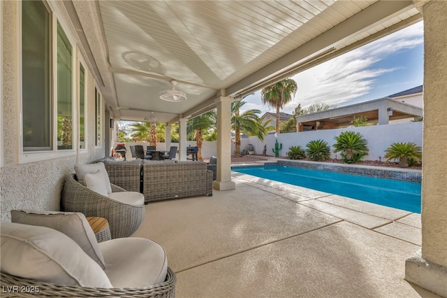 view of pool featuring an outdoor living space and a patio area