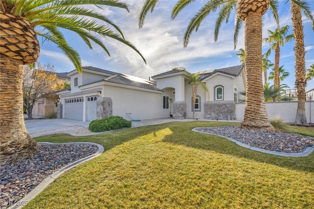 view of front of house with a garage and a front lawn