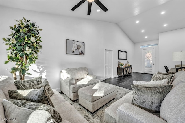 living room featuring lofted ceiling, dark wood-type flooring, and ceiling fan