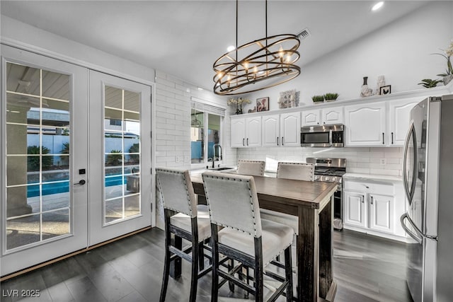 kitchen featuring stainless steel appliances, sink, white cabinets, and french doors