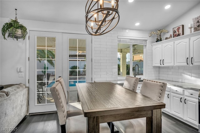 dining room featuring a notable chandelier, dark wood-type flooring, and french doors