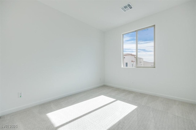 unfurnished room featuring light carpet