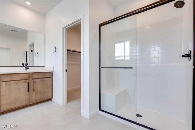 bathroom with vanity, an enclosed shower, and tile patterned floors