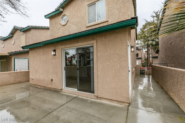 view of property exterior with a patio