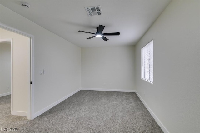 empty room featuring light colored carpet and ceiling fan