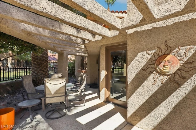 view of patio / terrace featuring fence, a pergola, and outdoor dining space