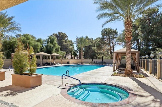 community pool featuring a hot tub, fence, a patio, and a gazebo