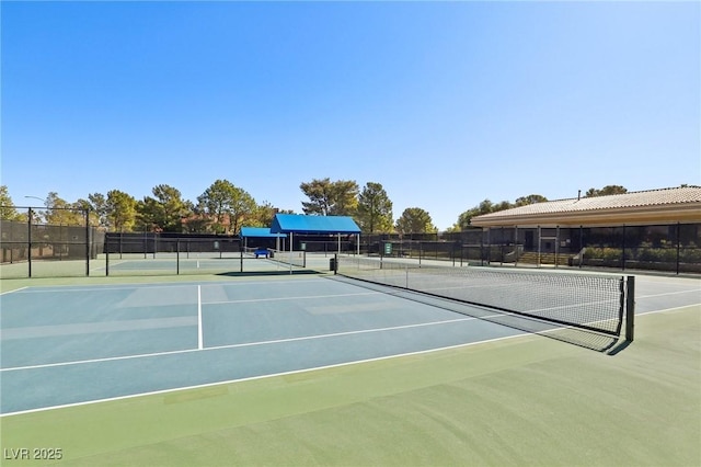 view of tennis court with fence