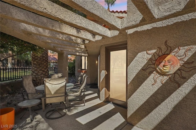 view of patio featuring fence, a pergola, and outdoor dining space