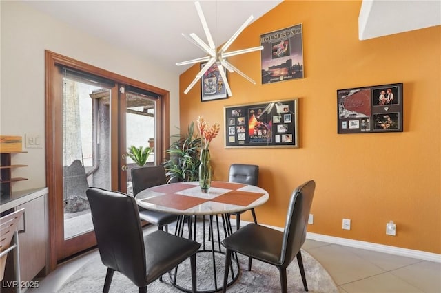 dining room with light tile patterned flooring and baseboards