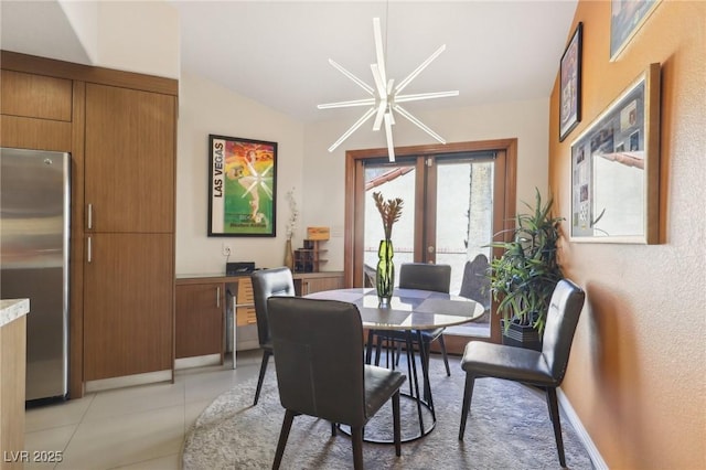 dining room featuring light tile patterned floors, vaulted ceiling, and french doors