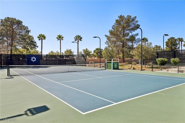 view of tennis court featuring fence