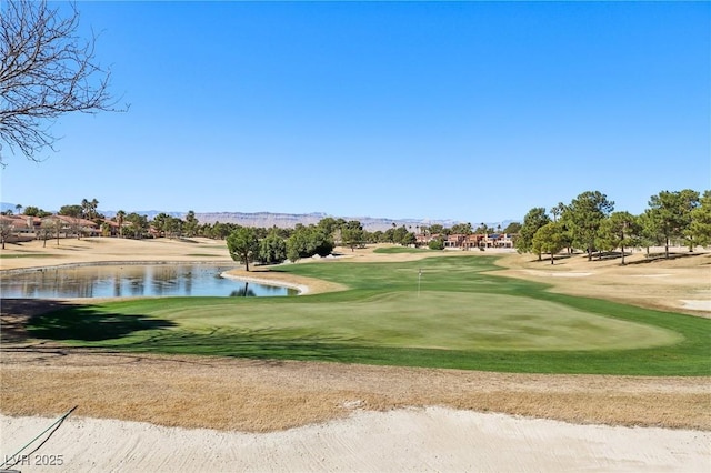 view of home's community featuring view of golf course and a water view