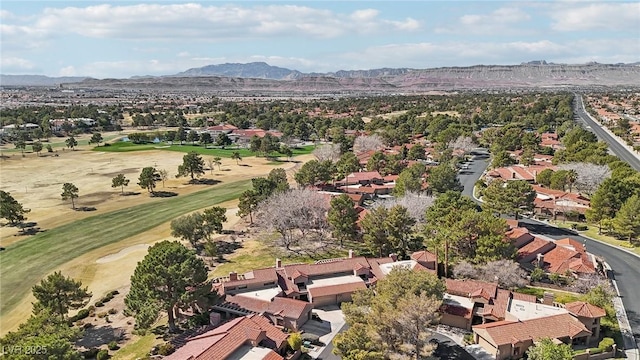 drone / aerial view featuring view of golf course, a residential view, and a mountain view