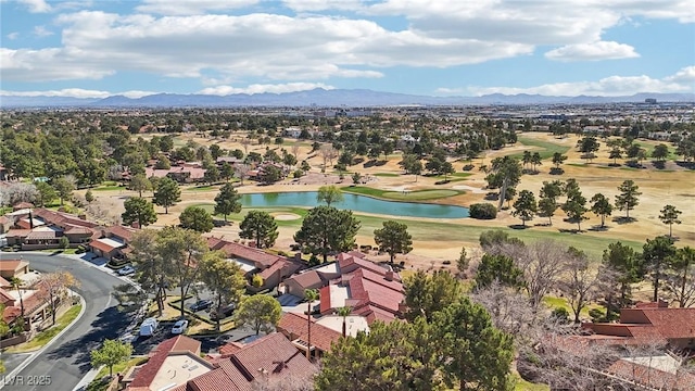 aerial view with view of golf course, a residential view, and a water and mountain view