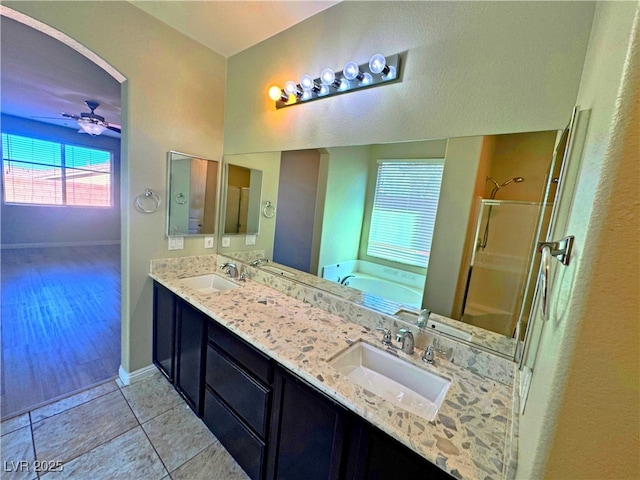 bathroom with ceiling fan, independent shower and bath, tile patterned flooring, and vanity