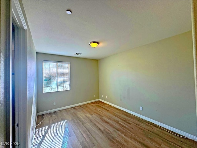 unfurnished room featuring light hardwood / wood-style floors