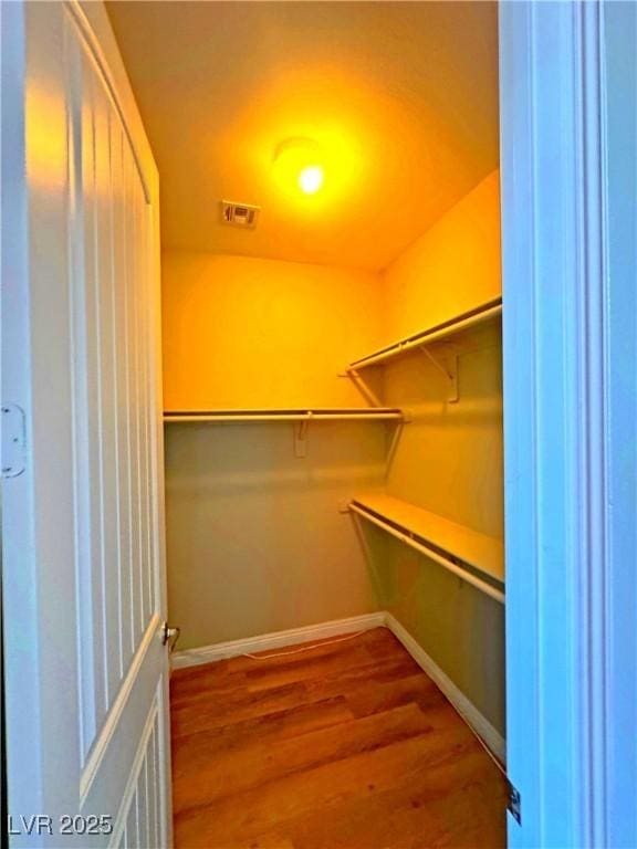 spacious closet featuring hardwood / wood-style floors